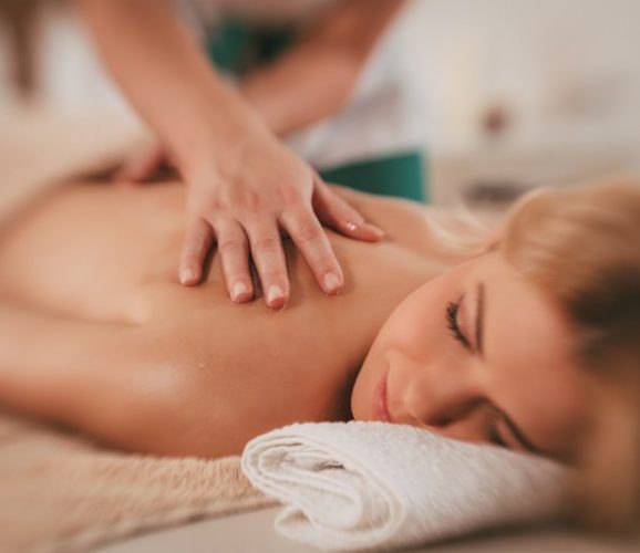 Woman enjoying during a relax massage at the spa.